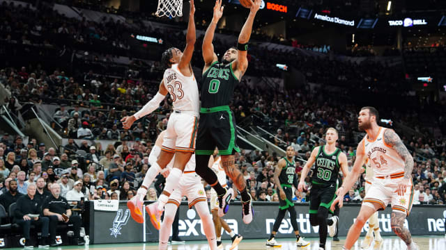 Dec 31, 2023; San Antonio, Texas, USA; Boston Celtics forward Jayson Tatum (0) shoots over San Antonio Spurs guard Tre Jones (33) in the first half at Frost Bank Center.